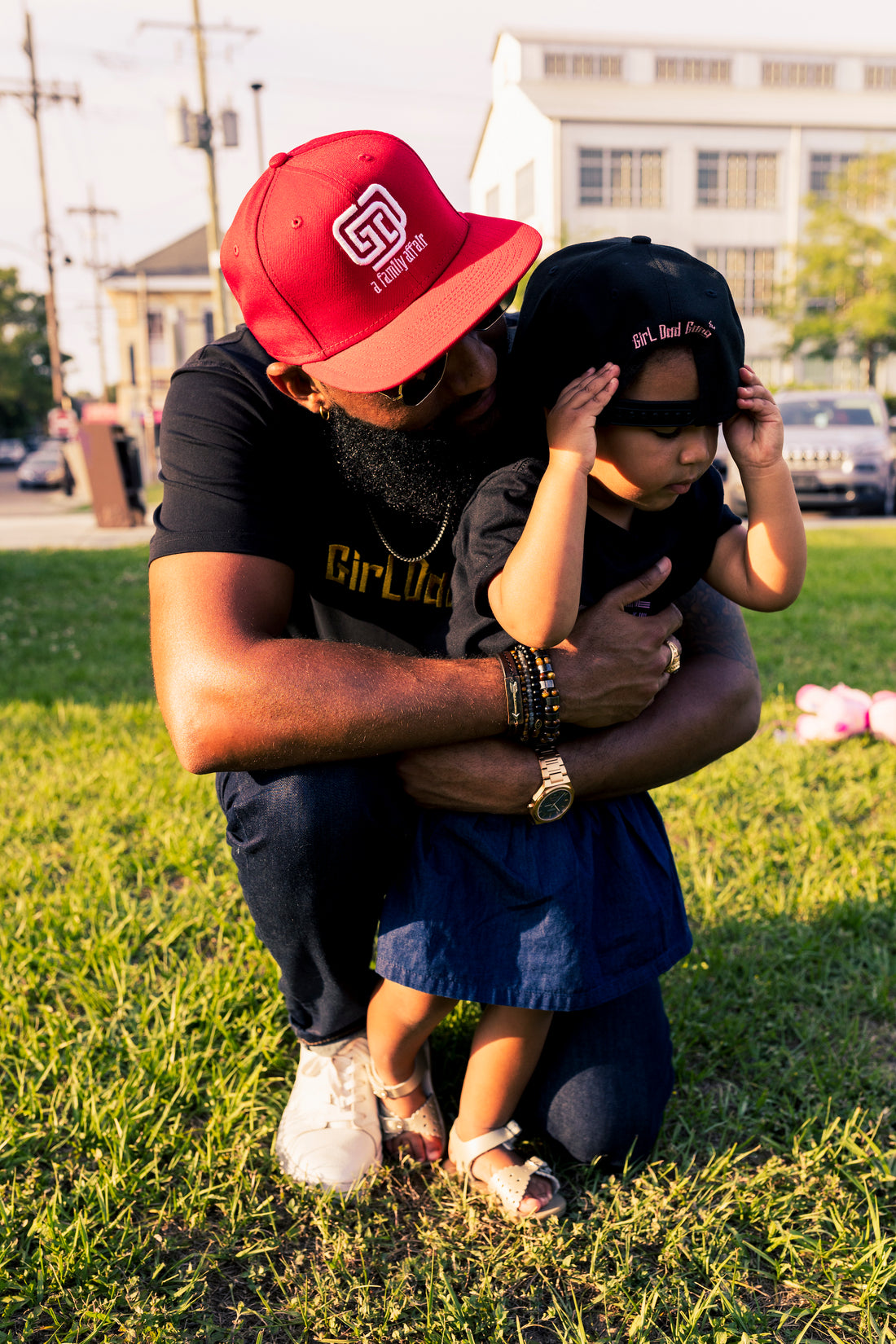 a father embracing his daughter, wearing girl dad gang gear